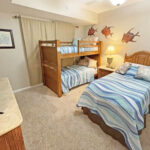 guest bedroom with twin bunkbeds and extra twin bed