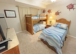 guest bedroom with twin bunkbeds and extra twin bed